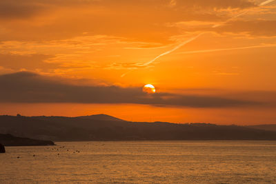 Scenic view of sea against orange sky