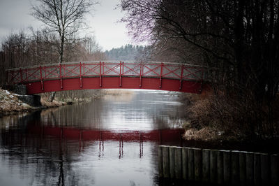 Arch bridge over river against sky