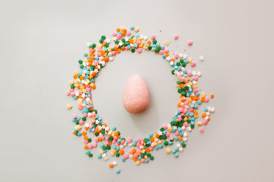 Close-up of multi colored candies against white background