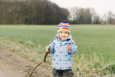 Portrait of girl standing on field