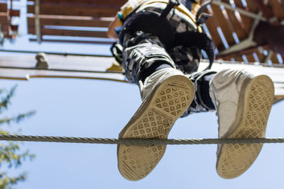 Low section of person wearing canvas shoes