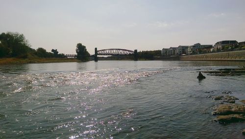 Bridge over river with city in background