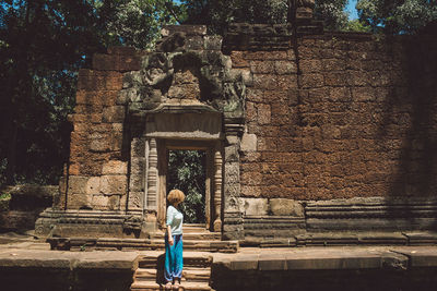 Tourist standing on steps of ancient temple