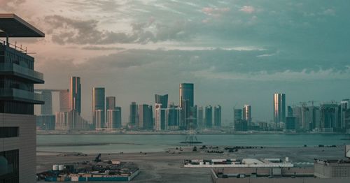 Panoramic view of buildings in city against sky