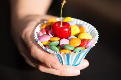 Close-up of hand holding multi colored candies