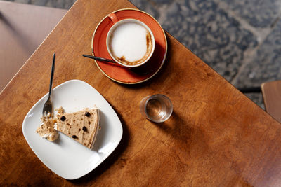 Overhead view of coffee, cheesecake on breakfast table. coffee mood