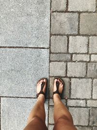 Low section of woman standing on tiled floor