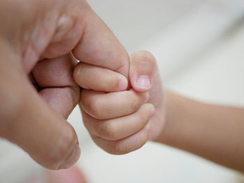 Close-up of baby holding hands