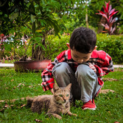 Full length of man and cat