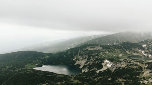 Scenic view of mountains against sky during foggy weather