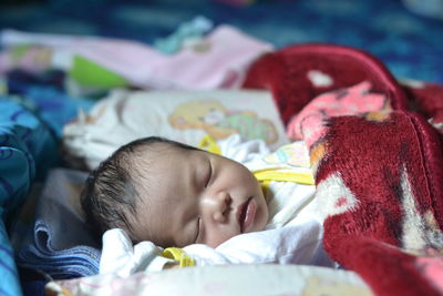 High angle view of baby boy sleeping on bed