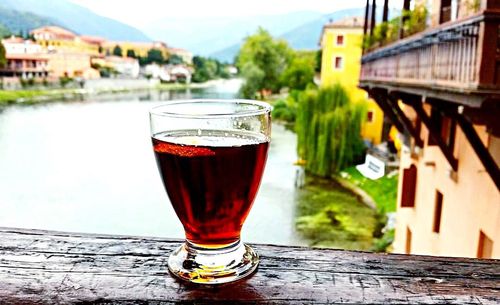 Close-up of beer in glass on table against sky