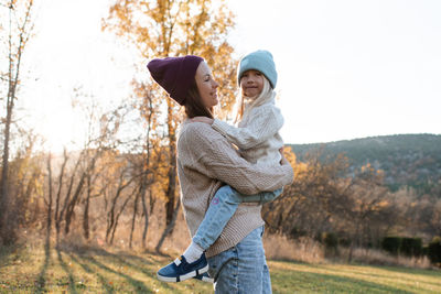 Side view of woman standing on field