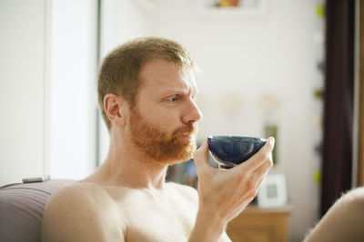 Portrait of young man drinking glasses