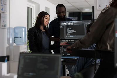 Side view of young woman working in office