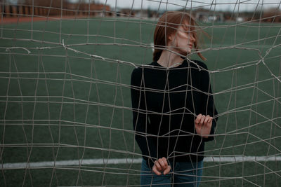 Young woman in cage