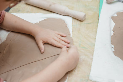 Women's hands knead clay, drawing elements of the product. production of ceramic products 