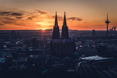 Aerial view of buildings in city during sunset