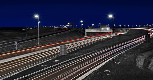 High angle view of light trails on road at night