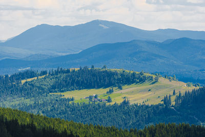 Scenic view of landscape and mountains against sky