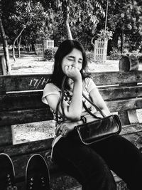 Portrait of smiling girl sitting in park