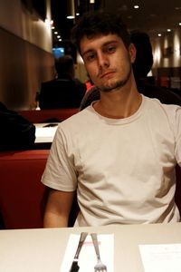 Portrait of young man standing in restaurant