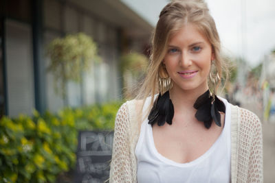 Portrait of smiling young woman standing outdoors