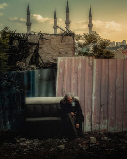 Woman sitting outside building