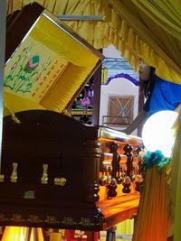 Low angle view of illuminated lanterns at temple