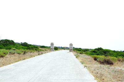 Road amidst landscape against clear sky