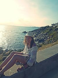 Portrait of young woman by beach