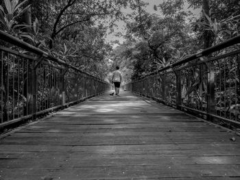 Rear view of man on footbridge