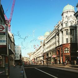 View of buildings against clear blue sky