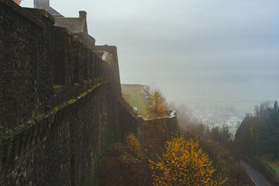Castle walls on a hill in the fog 