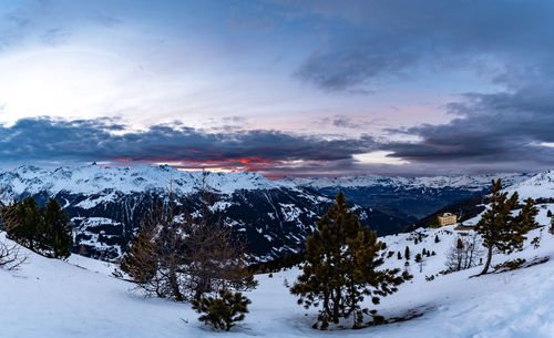 Scenic view of snow covered mountains against sky during sunset