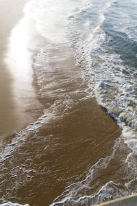 High angle view of waves on beach