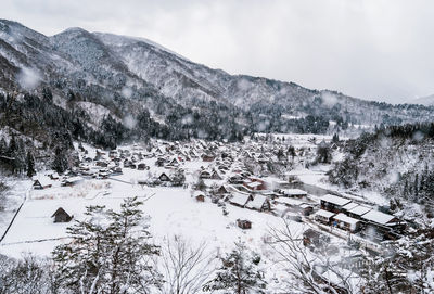 Scenic view of snow covered mountains against sky