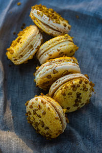 Textured yellow color lilikoi passionfruit turmeric sweet macaron sandwich cookies filled with cream