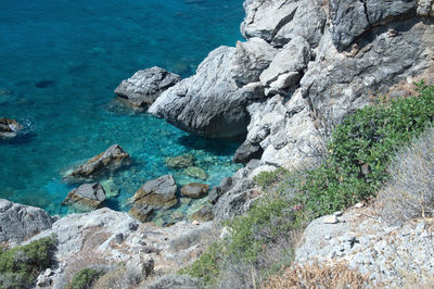 High angle view of rocks by sea