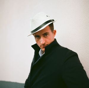 Portrait of young man against wall