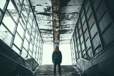 Low angle view of man in abandoned building