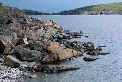 Rocks on beach against sky