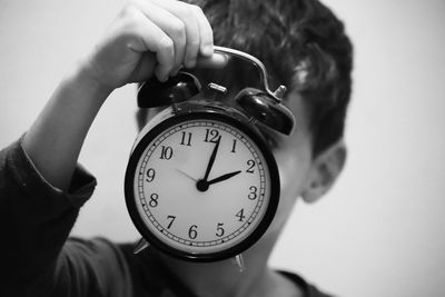 Cropped hand holding clock