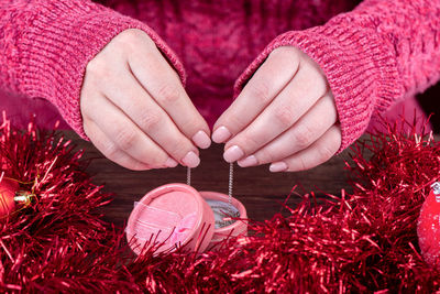 Midsection of woman holding christmas decoration