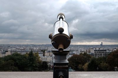 View of cityscape against cloudy sky