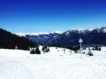 Scenic view of snow covered mountains against clear sky