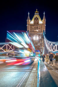 Illuminated bridge against clear sky at night