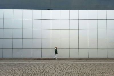 Full length of man standing against built structure