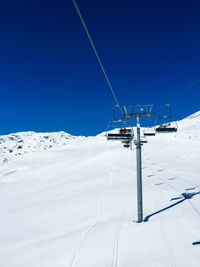 Ski lift on snow against clear sky