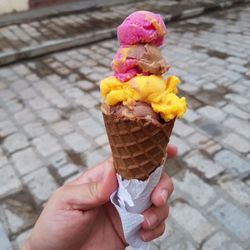 Cropped hand holding ice cream cone